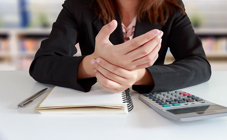 woman with ergonomic pain in office