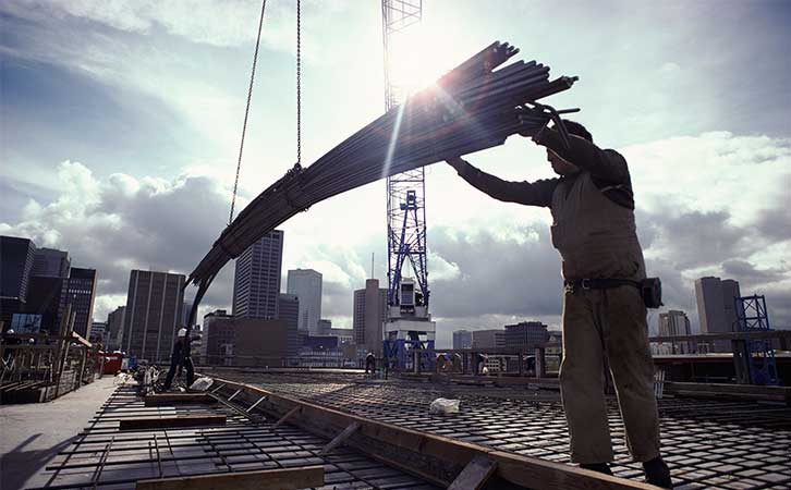 construction crane hoisting steel re-bar