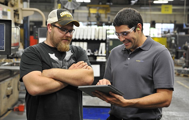 One manufacturing discussing assessment results from a tablet with an ergonomist