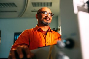 Man wearing glasses at computer