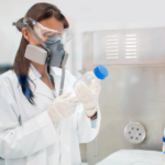 Woman wearing respirator in laboratory