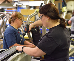 Women working to assemble equipment