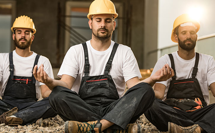 Construction workers practicing mindfulness