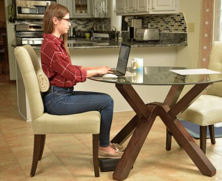 Woman sitting at table working on laptop