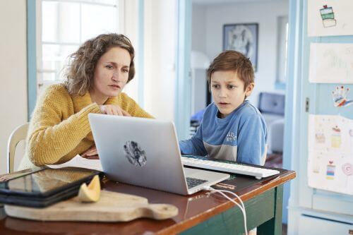 Mother and son looking at laptop