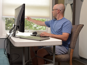 Man working in a laundry room while at home. 