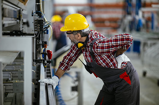 Factory worker experiencing back pain