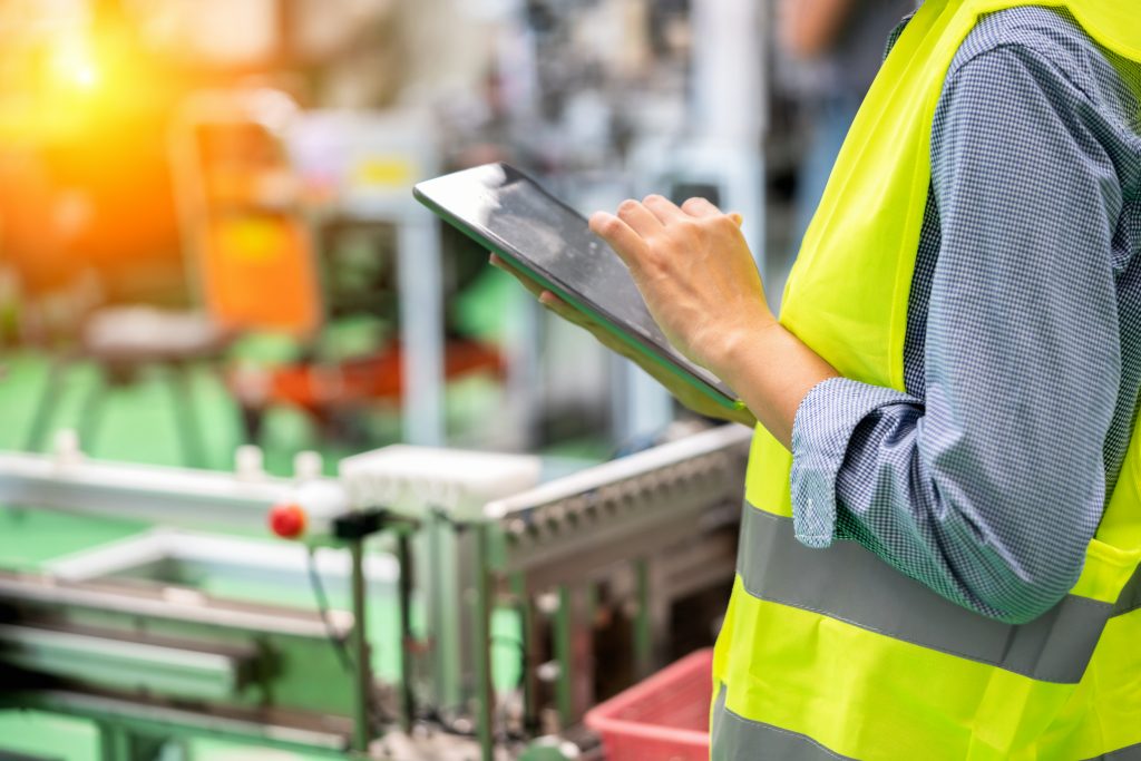 Image of person using a tablet in an industrial workplace