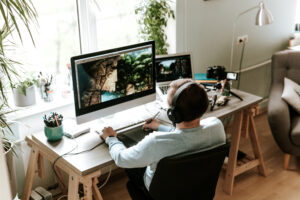 Man working from home surrounded by plants and sunlight