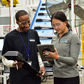 Two workers looking at screen